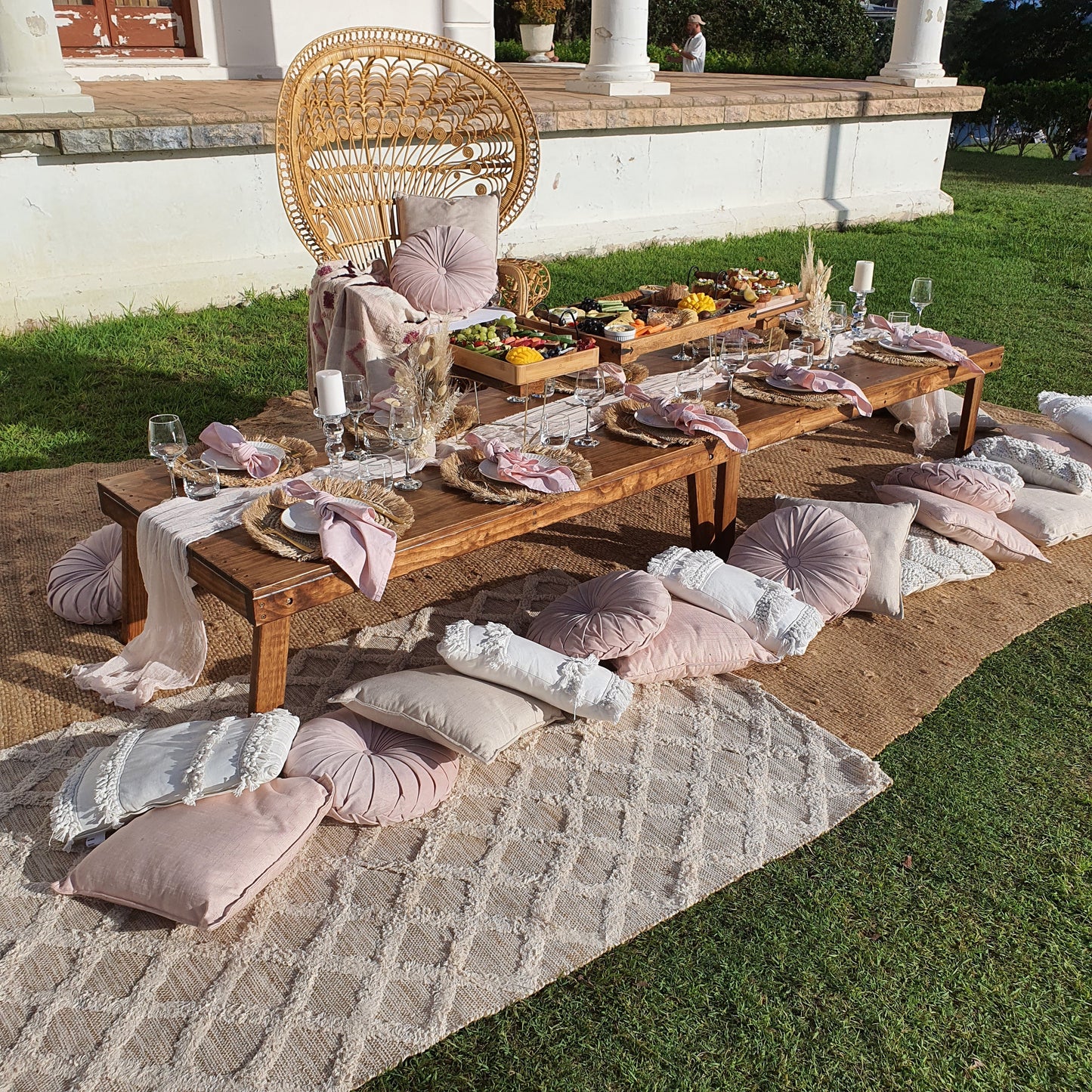 hens party pop up picnic setup with comfy cushions, rugs, peacock chair, linen napkins, table styling and grazing board