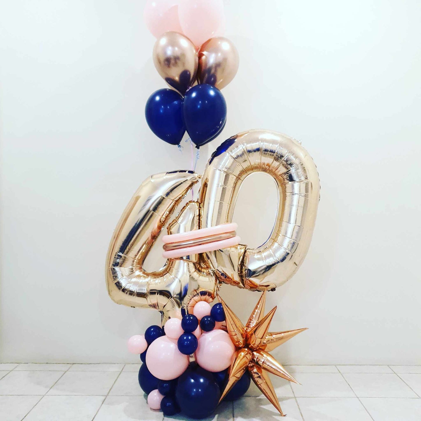 Double digit balloon decoration. Balloon marquee with 2 Large foil balloon numbers, happy birthday balloon and helium balloon marquee. Designs may vary.