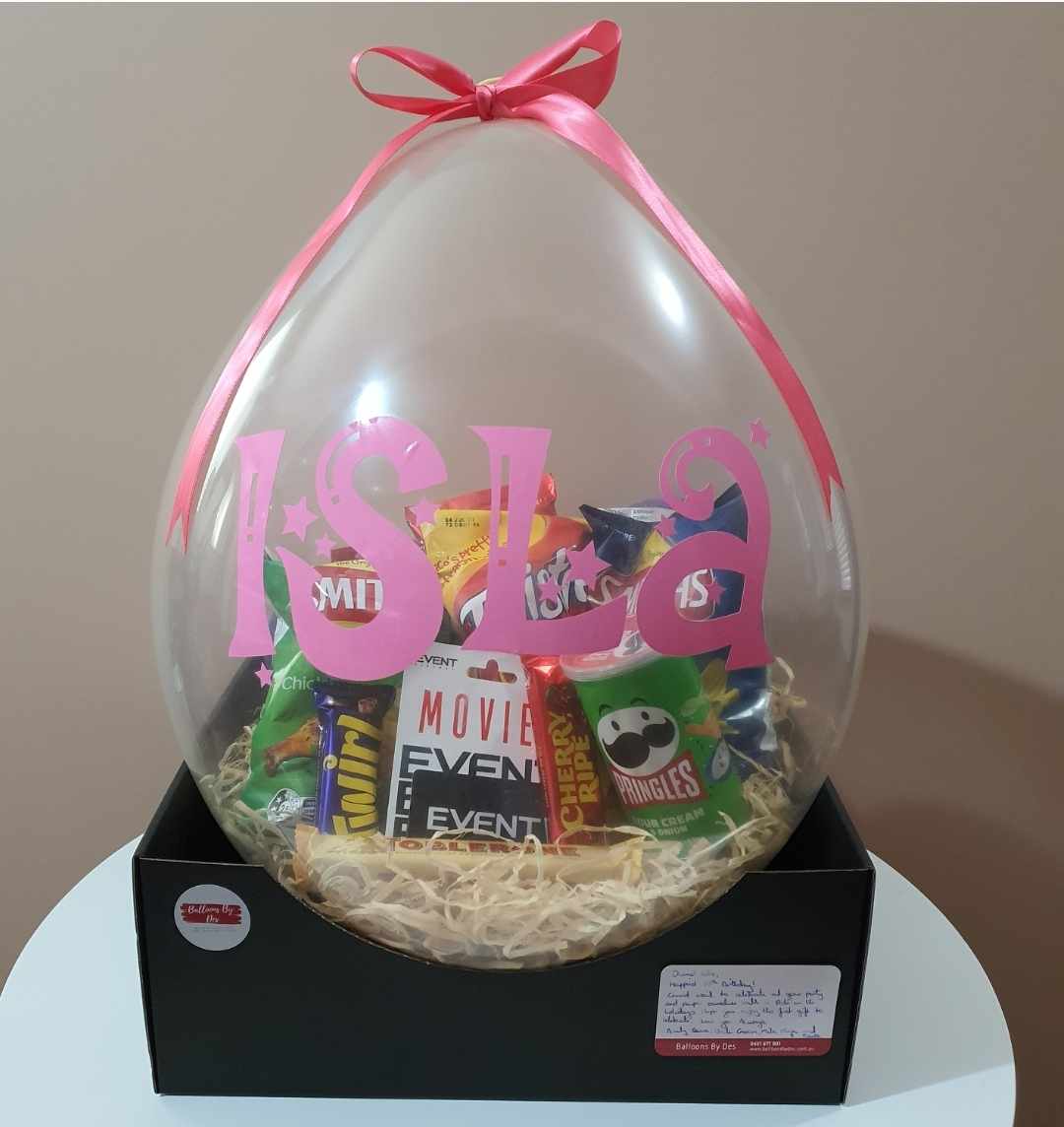 Large clear balloon stuffed full of their favourite snacks for teenage birthday gift idea. Movie vouchers included