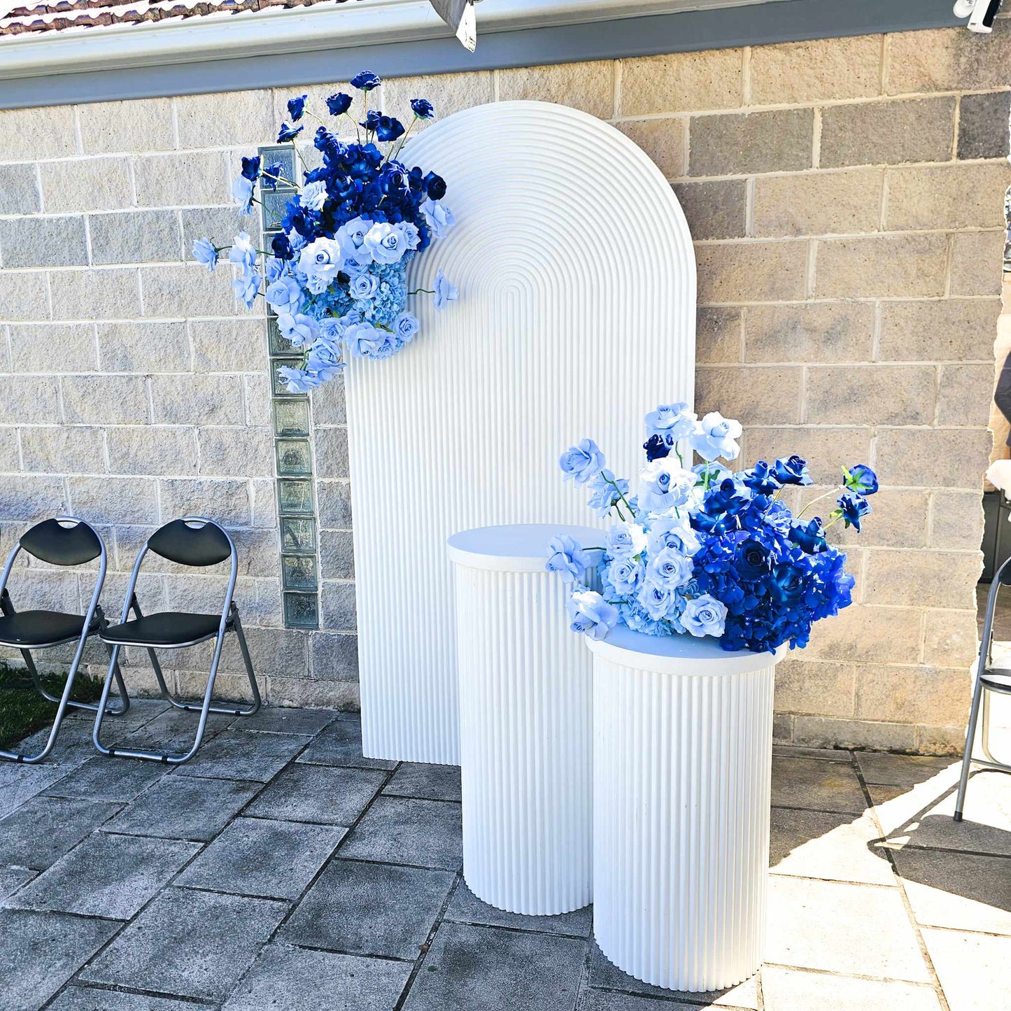 White Ripple arch backdrop with Large and medium white ripple plinths and blue floral arrangements for a blue bridal shower "something blue before I do"