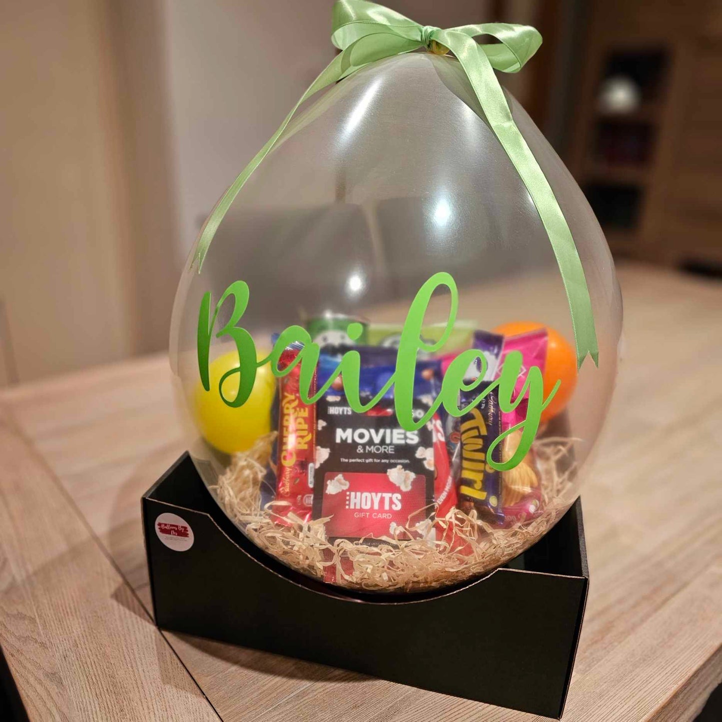 Large clear balloon stuffed full of their favourite snacks for teenage birthday gift idea. Movie vouchers included