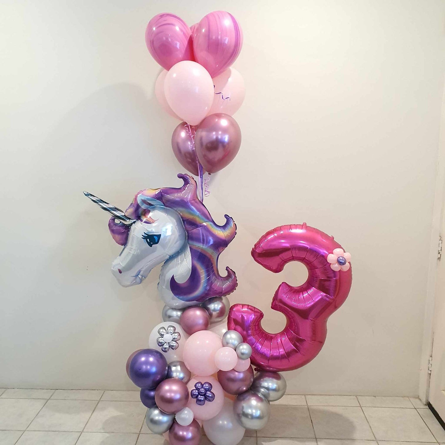 Unicorn balloon decoration, balloon marquee with unicorn head foil balloon, Jumbo Foil Number balloon and helium balloon bouquet.