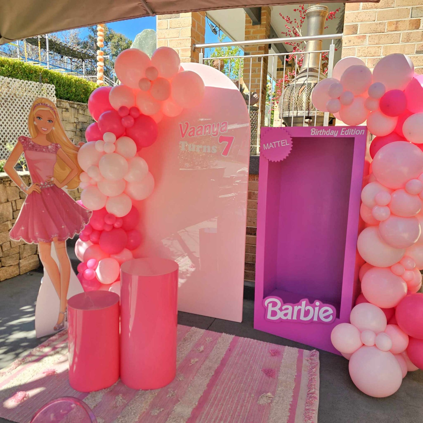 Barbie doll cutout with our hot pink acrylic plinthsand hot pink photo boothj with an organic balloono garland for children's party