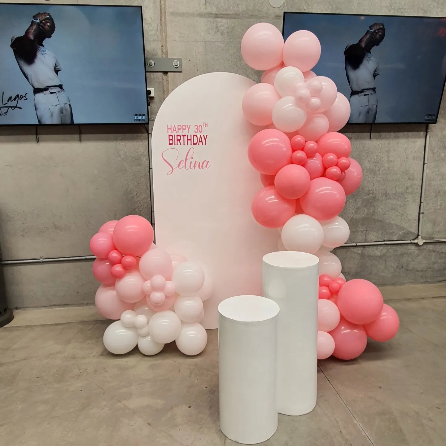 White arch backdrop with personalisation and 2 acrylic plinths medium and small. 3m of balloon garland decor in pastel matte pink, rose and white