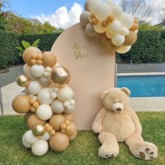 Sail arch backdrop with Neutral balloon garland and oversized teddy bear suitable for Birthdays, baby showers and more.