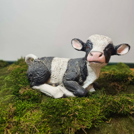 Cow prop lying on a grassy surface with a blurred background